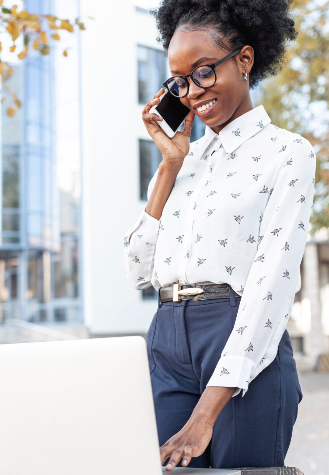 modern-woman-working-laptop-talking-phone